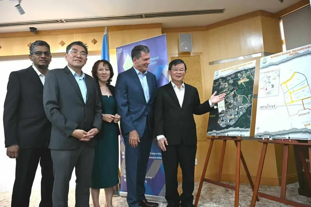 Officials with the Bandar Cassia Technology Park site plans showing Intuitive's plot, at the 14 August announcement.