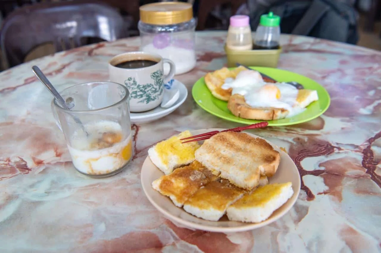 The classic order: traditional coffee, half-boiled eggs and kaya toast. Photo: Siew Chia En/Buletin Mutiara