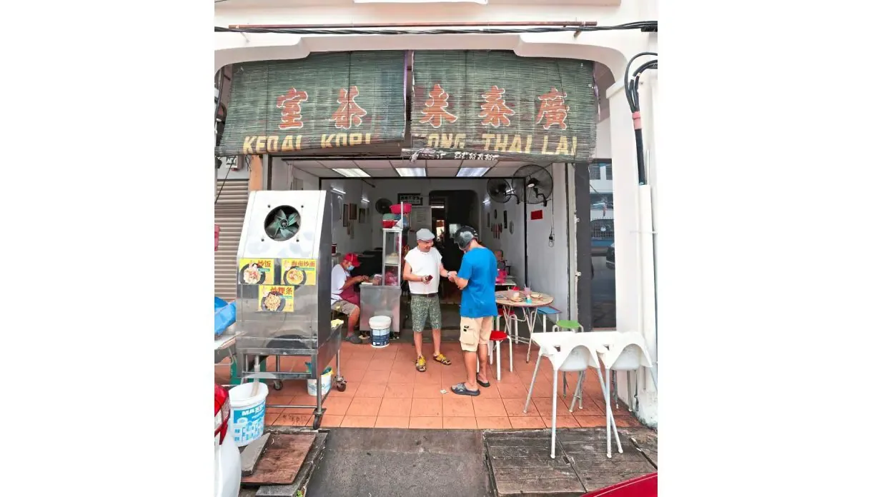 A toast to 106: third-generation operator Tan Jeng Seow outside Kong Thai Lai at Lebuh Dickens, George Town. Photo: Zhafaran Nasib/The Star