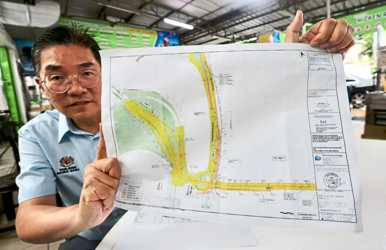 峇央峇鲁国会议员沈志勤展示连接槟岛与木蔻山的大桥规划图。照片：Zhafaran Nasib／《星报》
